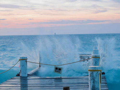 Waves crashing a dock in Turks & Caicos